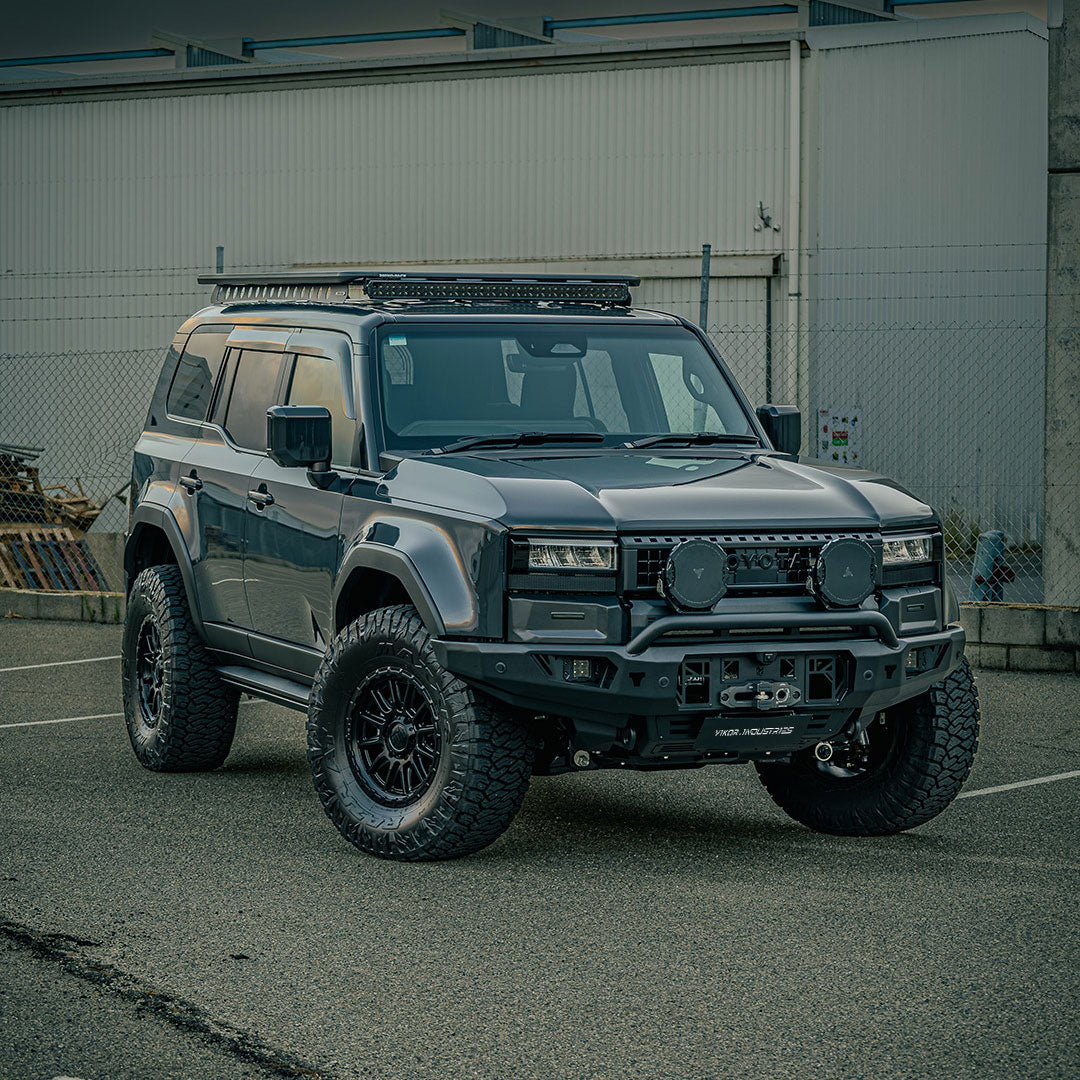 Toyota Prado 250 Series SUV with a black Diablo Bull Bar installed on the front. The vehicle is parked, and the bull bar features LED lights and a rugged design.