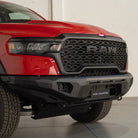 Red Ram truck with a black front bumper in a showroom setting